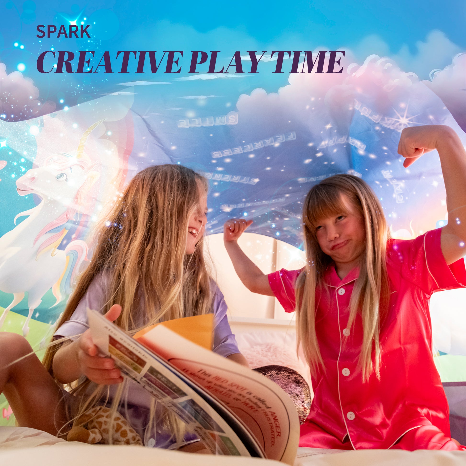 Two girls being silly reading books under the Dream Tent.